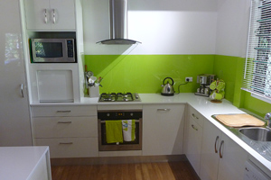 Tambour door, white and lime green kitchen