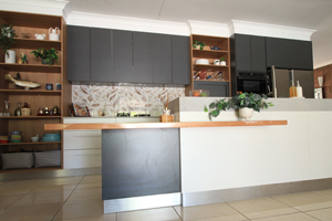Galley style kitchen with low breakfast bar